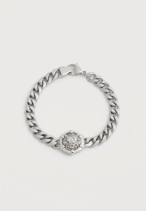 Bracelet chaîne en argent avec un médaillon tête de lion au centre et une fermeture à mousqueton.