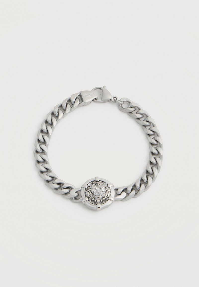 Bracelet chaîne en argent avec un médaillon tête de lion au centre et une fermeture à mousqueton.