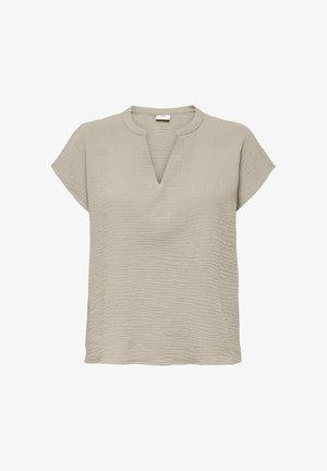 Blouse beige à manches courtes texturée avec un col en V fendu et un col arrondi, fabriquée en tissu léger.