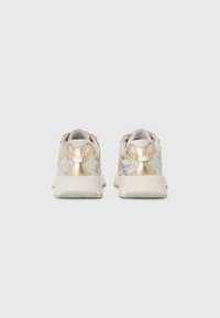 White and gold sneakers with a textured upper, featuring metallic accents and a thicker sole design. Rear view displays logo detail.