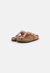 Pink flip-flop sandals with a cork footbed, rubber outsole, and a buckle accent. Features smooth straps with a slight sheen.
