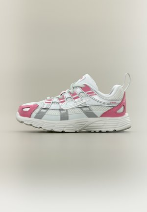 Weißer und rosa Sportschuh mit Mesh- und synthetischen Überlagerungen, grauen Akzenten, dicker Sohle und Zuglasche an der Ferse, Seitenansicht auf neutralem Hintergrund.