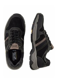Black hiking shoes with gray and brown accents, made from suede and textile. Features sturdy soles, laces, and contrasting stitching details.