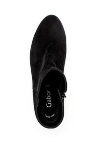 Black suede ankle boot with a rounded toe, zip closure on the side, and a soft texture. Inside features brand logo with size information.
