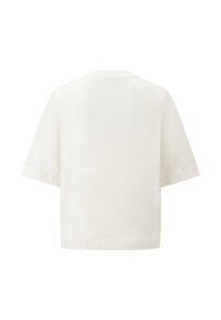 Krátký rukáv tričko z bavlny v krémové barvě se rovnými liniemi a kulatým výstřihem. Zadní pohled ukazuje hladkou strukturu a jednoduchý design.