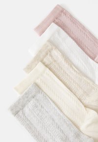 Five pairs of socks in pastel colors: pink, white, beige, cream, and light gray. Each features a textured ribbed pattern with a soft finish.