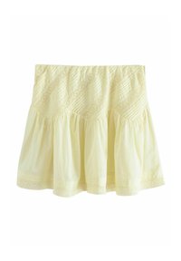 Jupe en coton jaune avec un design évasé, une texture froncée et des détails en dentelle décorative le long de la couture supérieure et de l'ourlet.