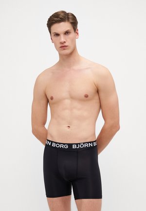 Schwarze Boxershorts mit einem breiten elastischen Bund, der mit "BJÖRN BORG" Branding versehen ist. Hergestellt aus einem glatten Stoff, haben sie ein enganliegendes Design.