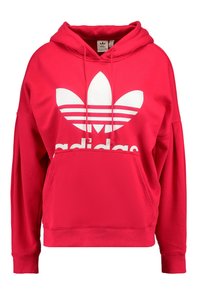 Röd bomullshoodie med känguruficka, prydd med en stor vit Adidas-logotyp och tre horisontella ränder på logotypen. Löst snitt, huva med dragsko.