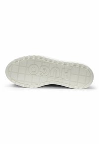 White rubber sneaker sole featuring a textured pattern and "HUGO" branding. The edge is raised with a ridged design for traction.