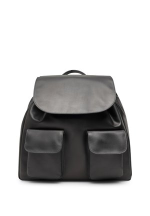 Black leather backpack with a large flap closure and two front pockets with flaps, shown against a white background.