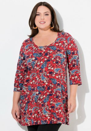 Rotes Tunika-Oberteil mit drei Viertel Ärmeln, featuring einen floralen und Paisleymuster in Blau und Weiß, und einem Rundhalsausschnitt.
