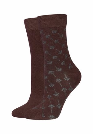 Pair of brown socks, one plain and one with a small light blue floral pattern, both with ribbed cuffs.