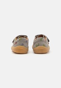 Grey suede shoes with colorful dinosaur patterns, velcro strap, round toe, and tan rubber sole. Logo "froddo" embossed on the heel.