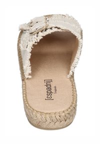 Beige espadrille sandal with frayed textile upper, an adjustable strap with silver hardware, and a woven jute sole. Flat design, open-toe style.
