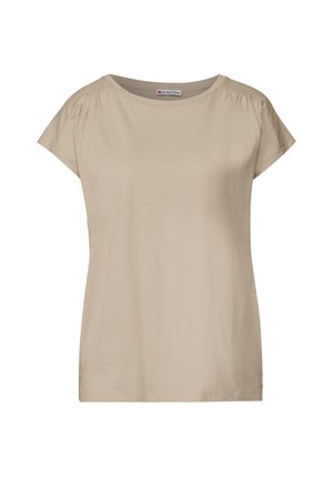 Vaaleanbeige lyhythihainen t-paita, jossa on pyöreä kaula-aukko ja pehmeä pinta. Hihansuissa on hillitty kerrostus, joka lisää suunnittelun yksityiskohtia.