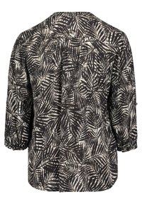 Black and cream patterned blouse featuring a leaf design, three-quarter sleeves, soft fabric, and a relaxed fit with a button detail on sleeves.