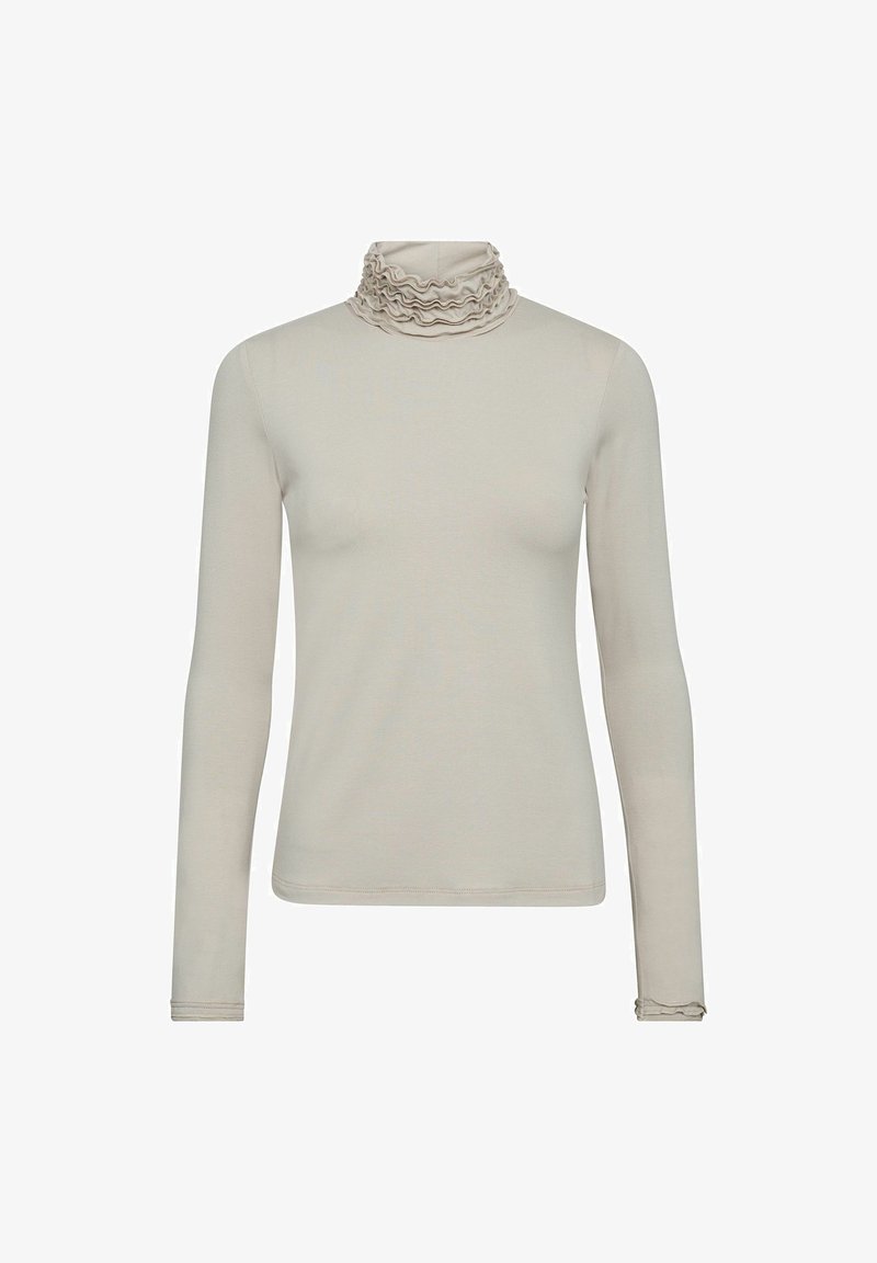 Haut beige à manches longues avec col roulé à volants superposés et poignets assortis à volants, design simple, sans motifs ni logos visibles.