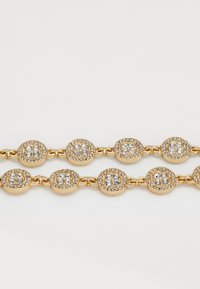 Two gold chains with round, gem-encrusted links featuring clusters of clear rhinestones on a white background.