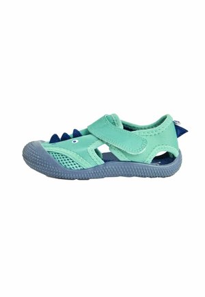 Hellgrüner Kinderschuh mit Mesh-Seiten, blauer Sohle, Klettverschluss und spielerischen blauen Stacheln an der Spitze. Weiches, leichtes Material.