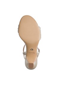 Μπεζ σανδάλι με τακούνι, με υφασμένο πάτο, ρυθμιζόμενο λουράκι στον αστράγαλο και διακοσμητικές λεπτομέρειες στο πάνω μέρος. Μέγεθος 37 σημειωμένο στο εσωτερικό.