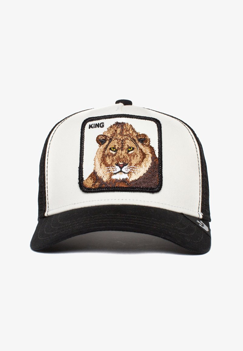 Schwarz-weiße Trucker-Cap mit einem gestickten Löwen-Patch und dem Wort "KÖNIG" darüber. Weicher Stoff mit strukturiertem Schnitt und einem gebogenen Schirm.