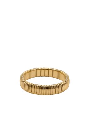 Gold-toned flexible coil bracelet with evenly spaced ridges, forming a circular band on a plain white background.