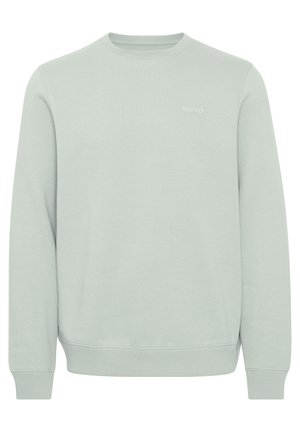 Hele rohelise värvi meeskonnakaelusega sviiter, mis on valmistatud pehmest kangast, ribaelastikest varrukate ja äärega, mille esiküljel on väiksem reljeefne "blend" logo.