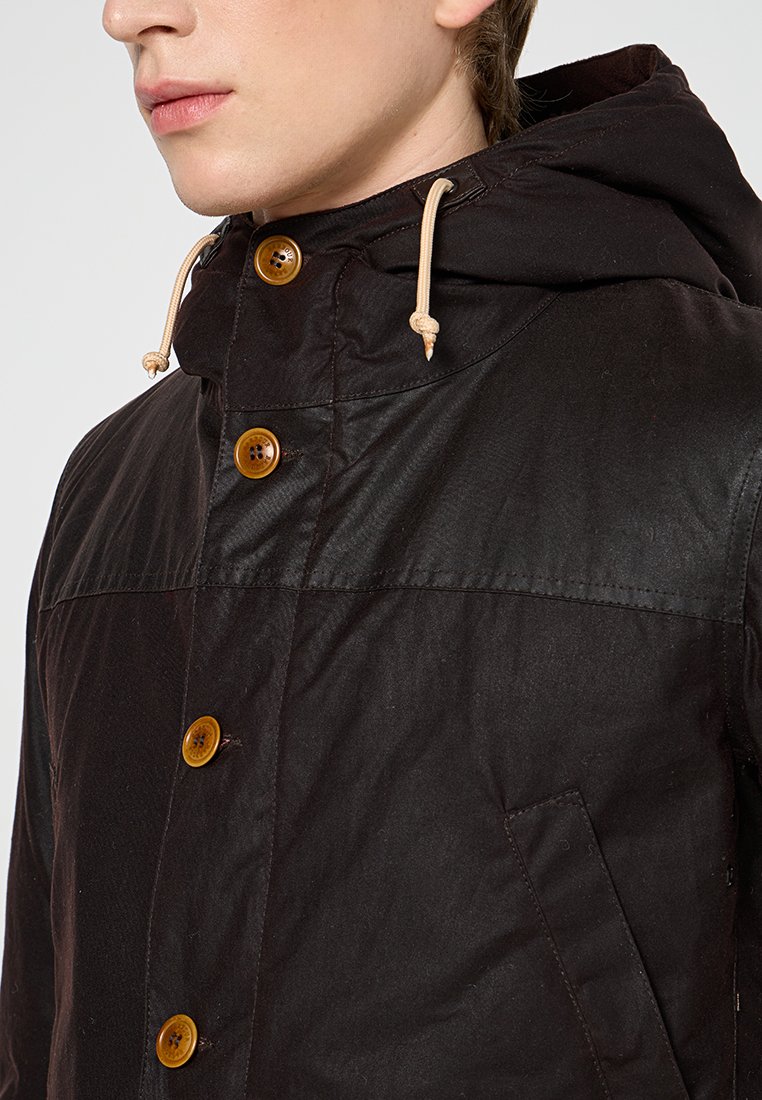 Brown jacket with a hood, featuring light brown buttons, drawstring accents, and a textured fabric. Includes a side pocket.