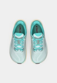 Light blue running shoes with a mesh upper, rounded toe, and beige sole. Features include lace-up closure and logo detailing on tongue.