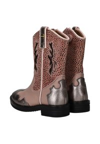 Pink leather ankle boots featuring cut-out designs, metallic accents, and a black rubber sole. Chunky heel and decorative stitching.