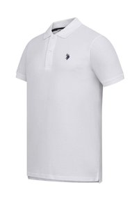 White polo shirt made of cotton with a classic collar, short sleeves, three-button placket, and a small black logo accent on the chest.