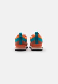 Chaussures de sport au design élégant en orange et bleu sarcelle, dotées d'une semelle en caoutchouc robuste et de textures contrastées sur la tige.