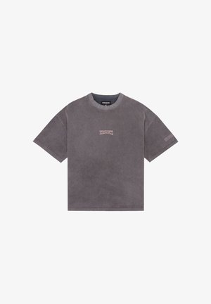 Oversized dark gray short-sleeve t-shirt with round neck and small light pink graphic text centered on chest and left sleeve.