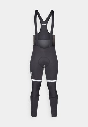 Black cycling bib shorts with adjustable straps, padded seat, reflective white accents on thighs, and stretchy, breathable fabric.