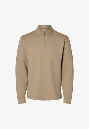 Jersey beige de manga larga con cremallera frontal parcial y cuello clásico, confeccionado en tela suave.