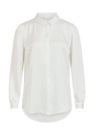 Chemise blanche à manches longues avec un col classique, présentant une texture lisse et une fermeture à boutons. Ourlet arrondi et manches légèrement bouffantes.