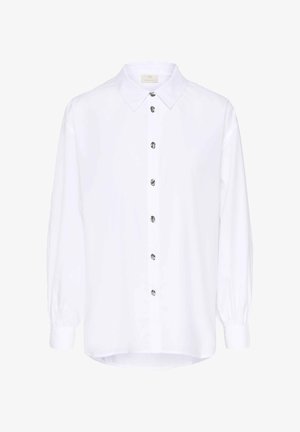 Chemise blanche à manches longues avec col classique, dotée d'un devant à boutons et de boutons métalliques. Texture lisse et ourlet arrondi.