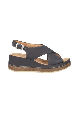 Sandalias de cuña abiertas en la parte delantera en cuero gris oscuro, con correas cruzadas y una correa ajustable en el tobillo. La suela texturizada ofrece agarre.