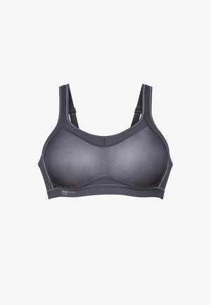 Brassière de sport noire avec panneaux en mesh, larges bretelles et bande élastique lisse. Présente un design structuré et une étiquette de marque à l'avant.