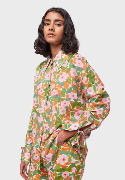 Camicia a fantasia floreale in tonalità di verde, rosa e arancione; design con bottoni e colletto; vestibilità ampia con maniche arrotolate e tasche.