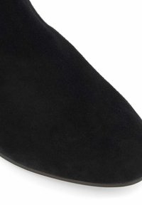 Black suede ankle boot with a pointed toe and smooth texture. The shoe features a minimalistic design and a slightly curved silhouette.