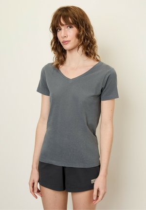 Gray cotton t-shirt with a v-neck and short sleeves, featuring a fitted design and a smooth texture. Worn with black shorts.