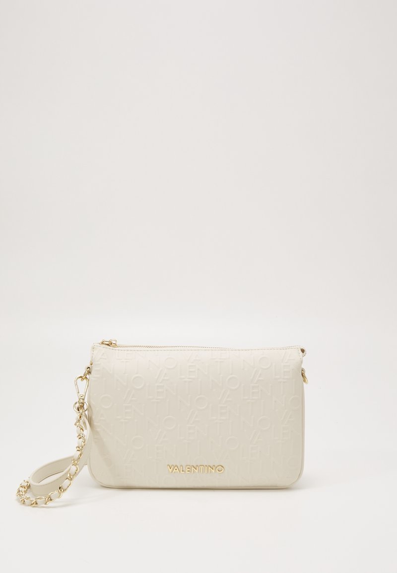 Beige leather clutch bag with embossed logo, gold hardware, detachable chain strap, and textured surface. Zip closure at the top.