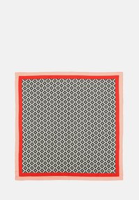 Square silk scarf featuring a black and white floral pattern with a coral and red border. Smooth texture with vibrant contrasting colors.