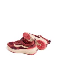 Red suede and mesh sneakers with cream accents, thick textured sole, and pink outsole. Features lace closure and pull tab at the rear.