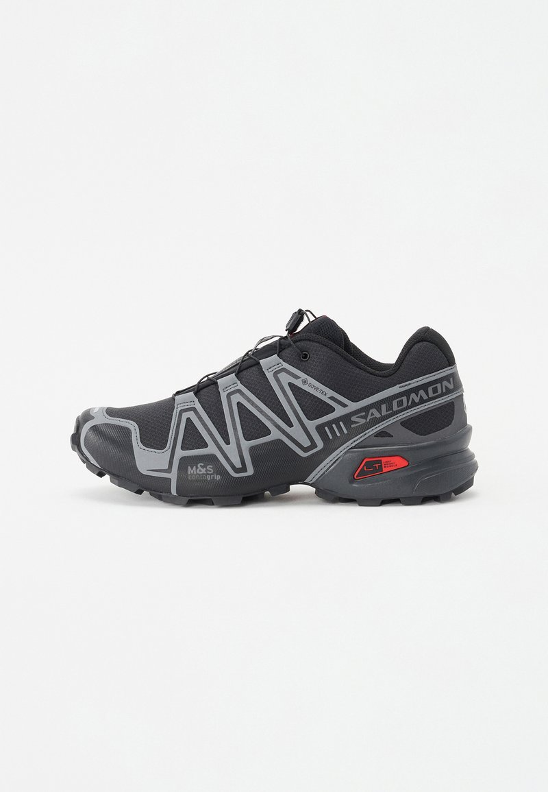 Black running shoe with grey accents, featuring a breathable upper, textured sole, and elastic lacing system for secure fit.