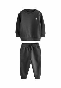 Ensemble de survêtement gris foncé en deux pièces, comprenant un haut à manches longues avec col ras du cou et un pantalon de jogging assorti avec une taille et des poignets élastiqués.