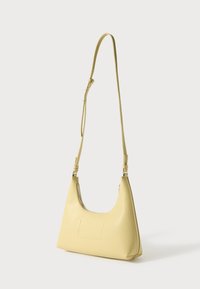 Yellow leather shoulder bag with a curved shape, adjustable strap, zip closure, and a subtle embossed rectangular detail on the front.