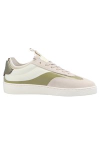 Sneakers featuring a tan suede upper with white and olive green accents, rounded toe, flat white sole, and a rear tab for easy wear.